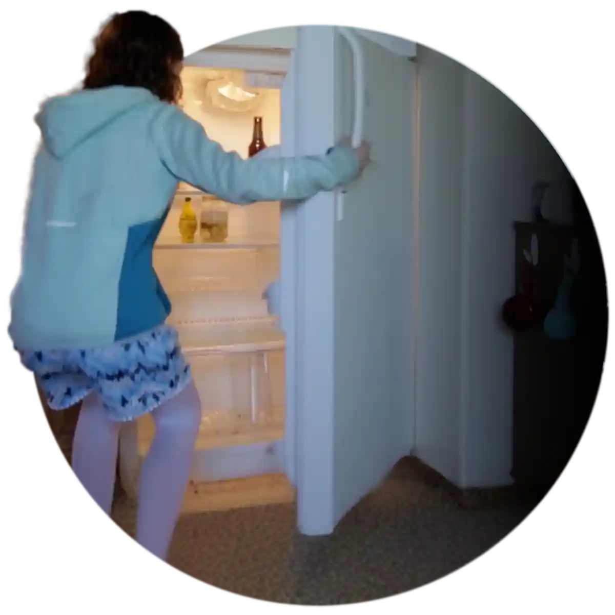 A girl looking in an empty fridge for food